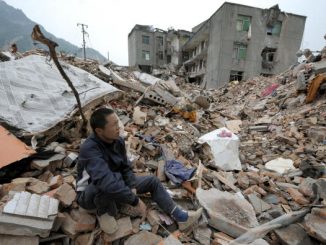2008年汶川大地震后，幸存者坐在瓦砾堆上。据民间组织巴蜀同盟会调查，这次地震死亡人数约30万人( LIU JIN/AFP/Getty Images)