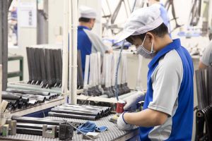 A worker produces components at the headquarters factory of