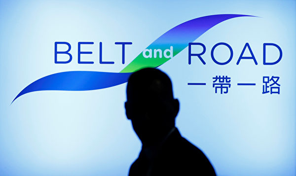 A man walks past the podium at the Belt and Road summit in Hong Kong